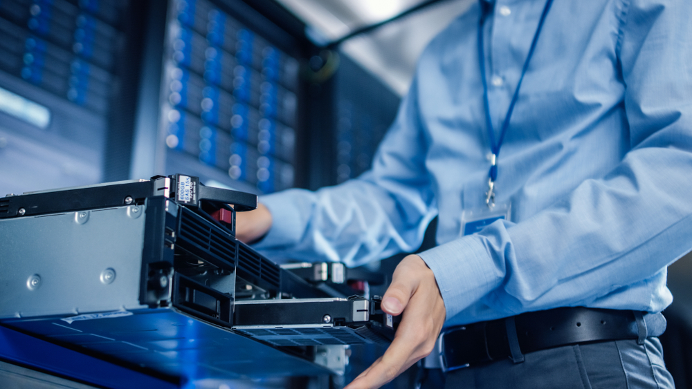 This is a photo of an engineer swapping out a hard disk.